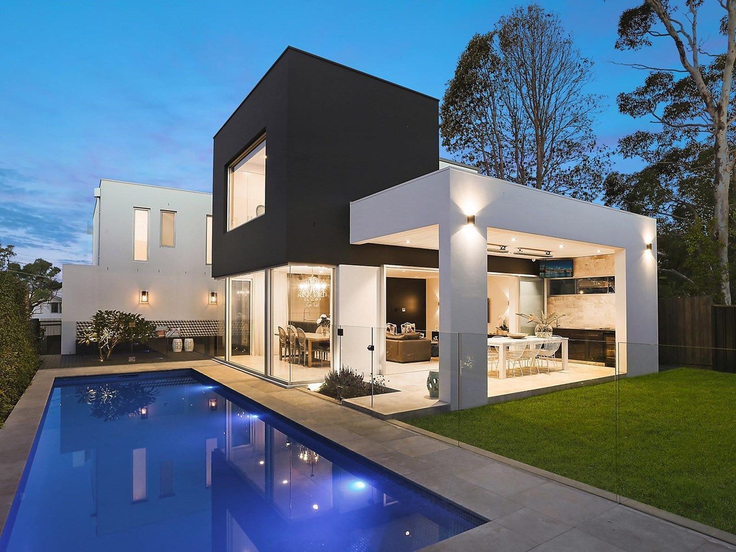 Architecturally designed home with pool at dusk, built by Foresight Constructions