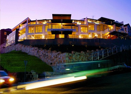 Hillside residence lit at dusk